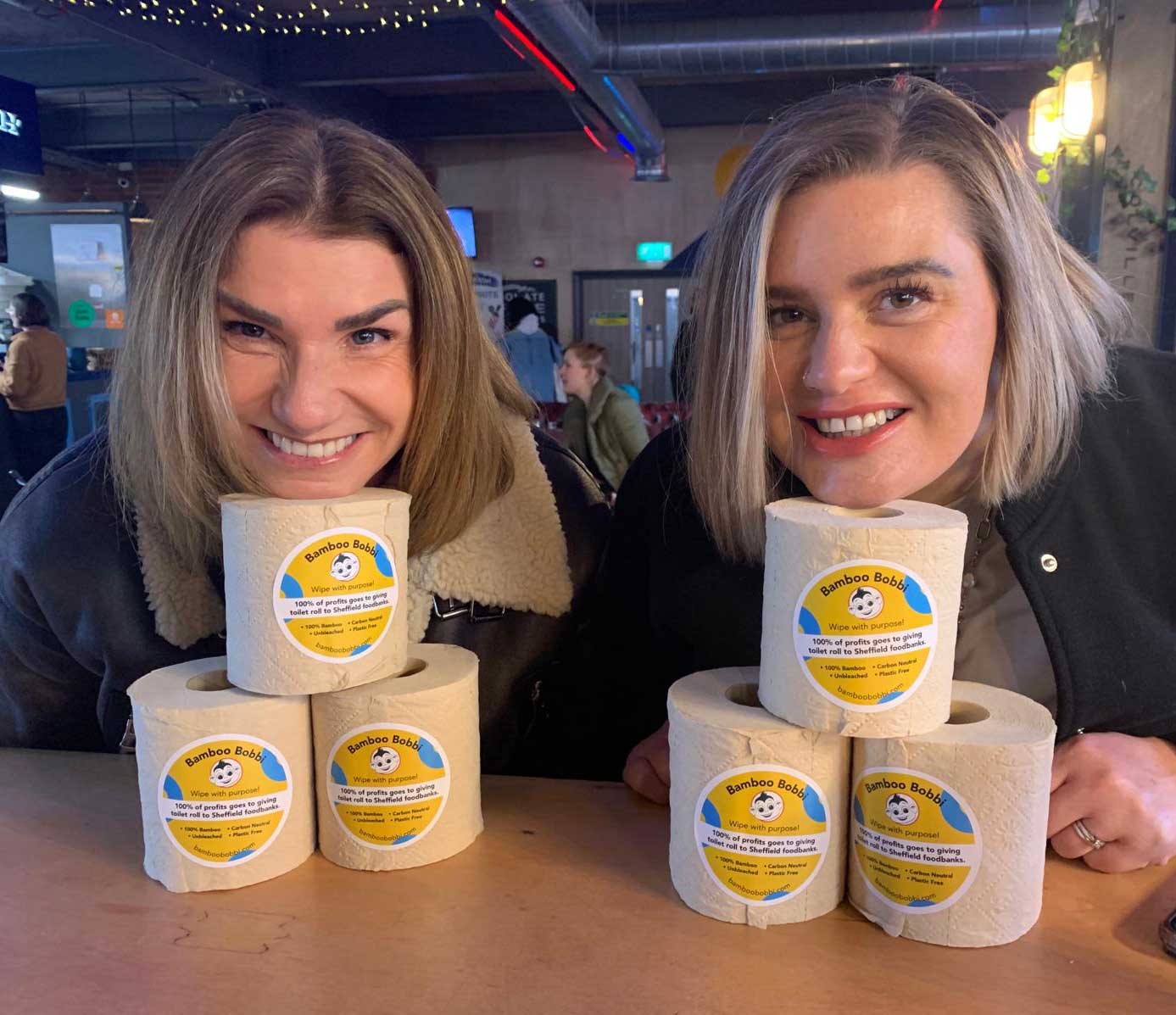 Two women leaning on Bamboo Bobbi rolls and smiling