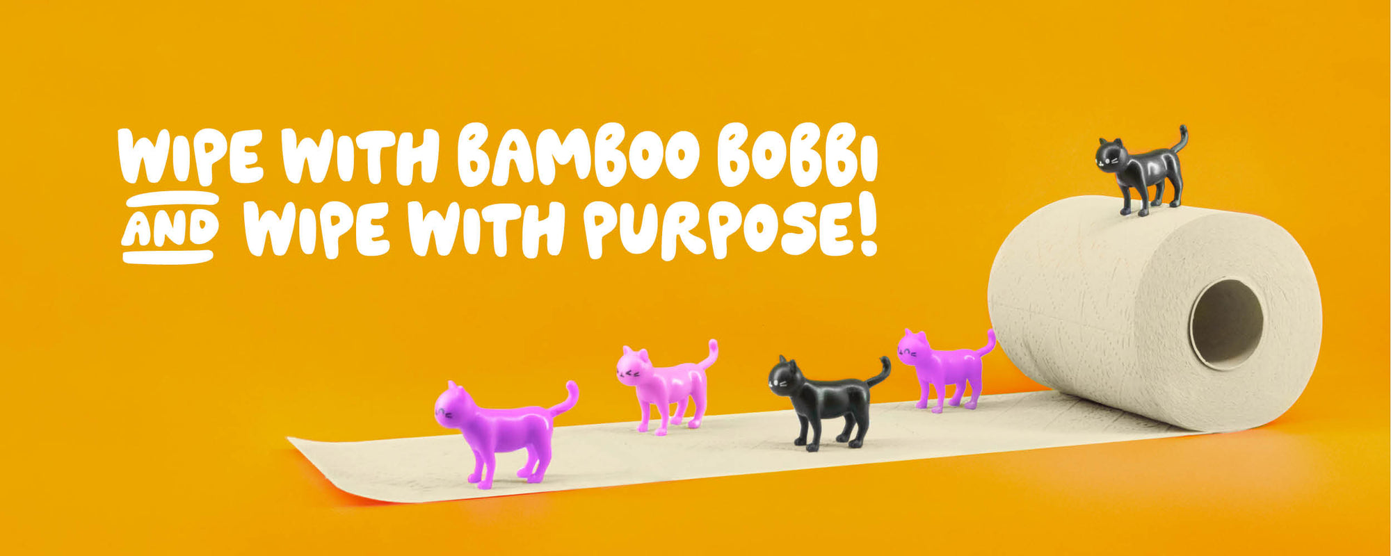 Roll of toilet paper with small dog figures on an orange background, featuring Wipe with purpose text about using bamboo Bobbi.