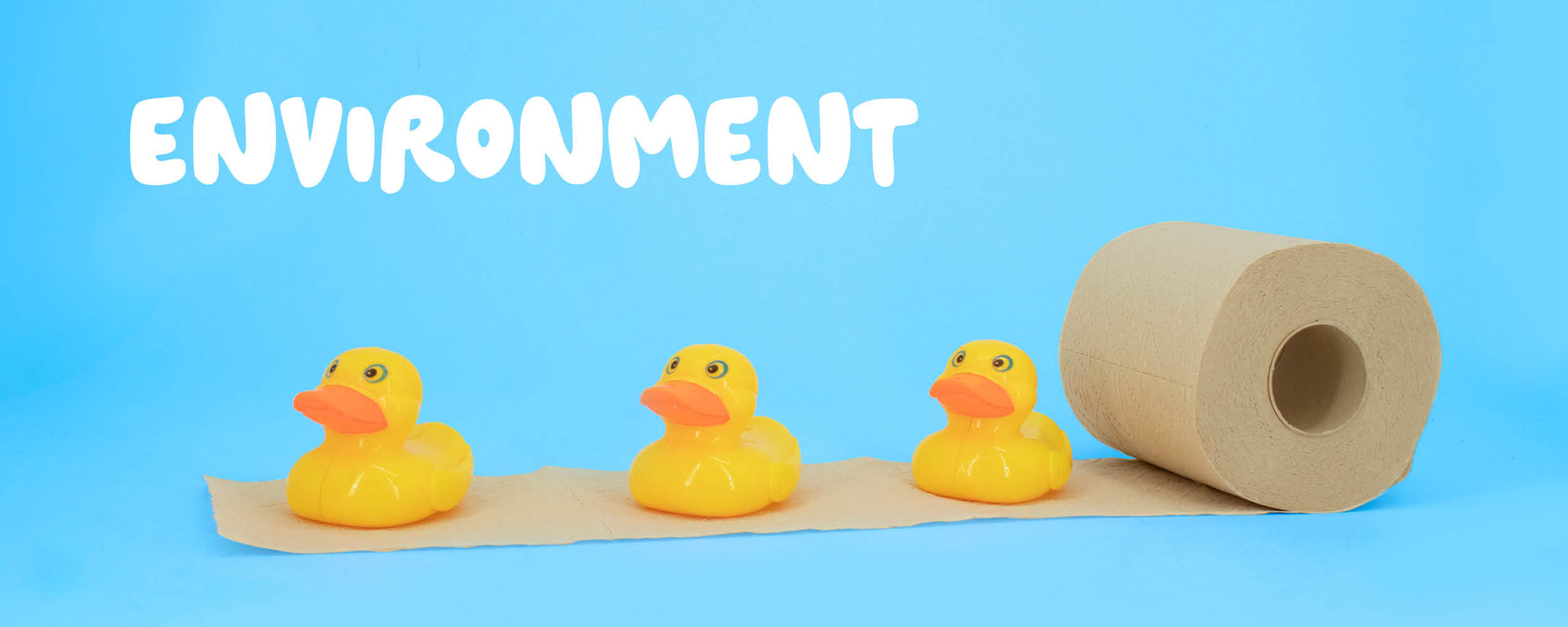 Three yellow rubber ducks on bamboo bobbi toilet paper, on a blue background with 'ENVIRONMENT' text.
